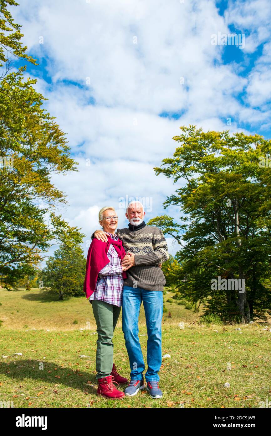Senior couple on a walk in an autumn nature. Stock Photo