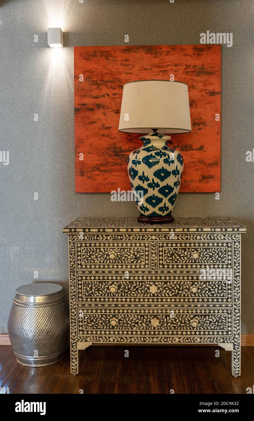 Antique chest of drawers with bedside lamp above Stock Photo Alamy