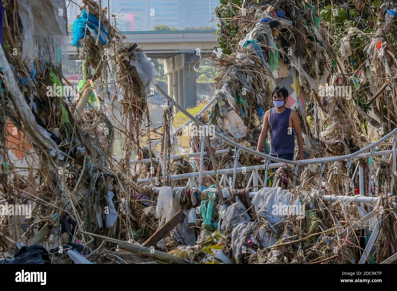 Beijing, China. 19th Nov, 2020. A man walks on a bridge covered in debris due to floods triggered by Typhoon Vamco in Marikina City, the Philippines on Nov. 19, 2020. Credit: Rouelle Umali/Xinhua/Alamy Live News Stock Photo