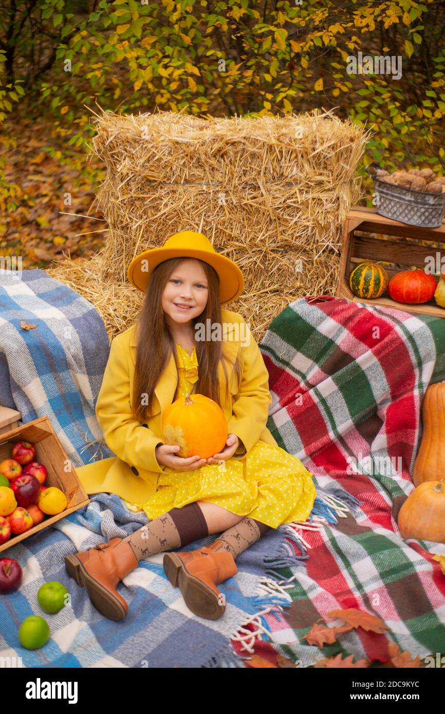 cute beautiful teenage brunette girl in an orange hat, dress and coat ...