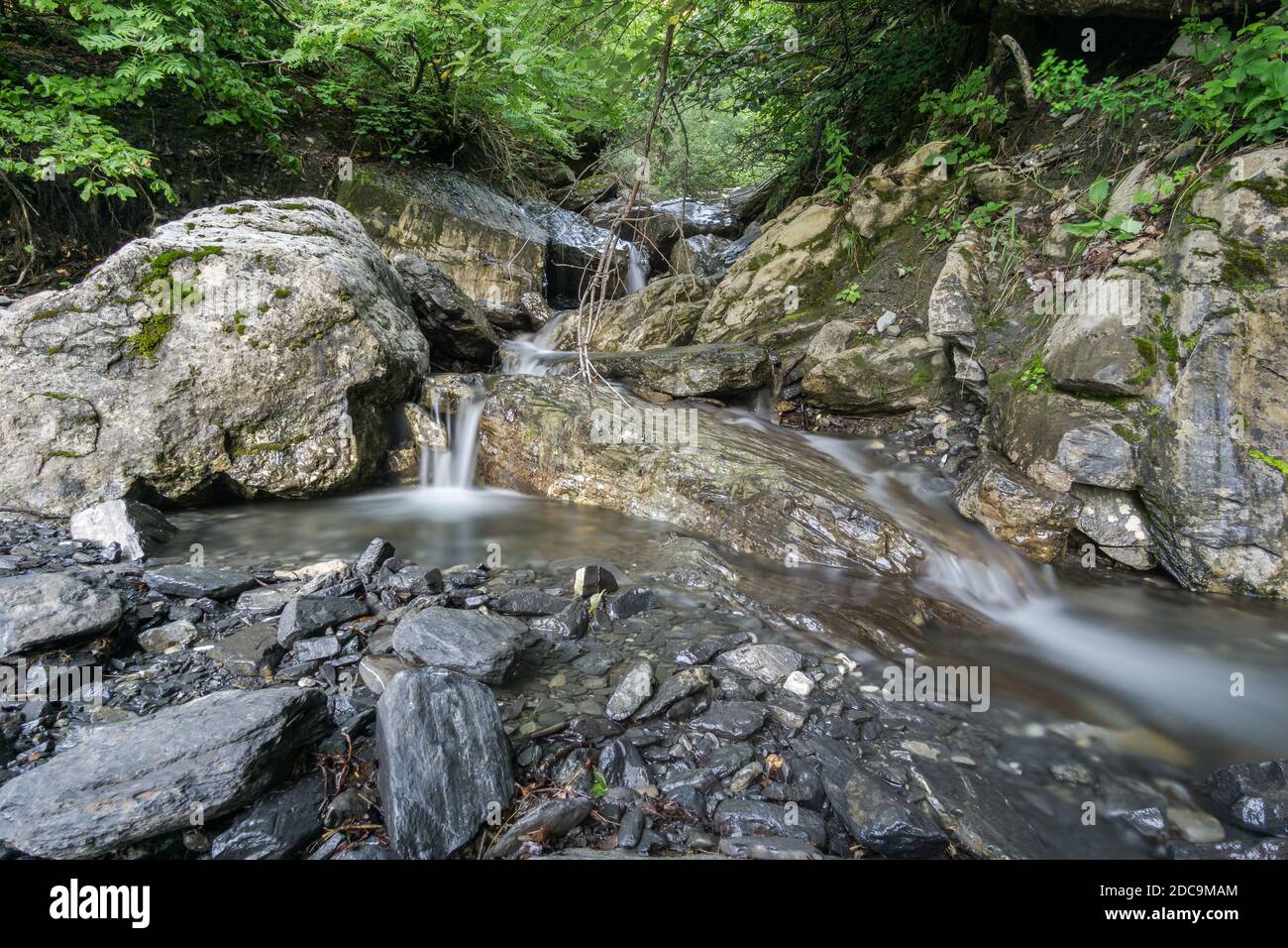 Wonderful clear water creek in french alps with rocks Stock Photo