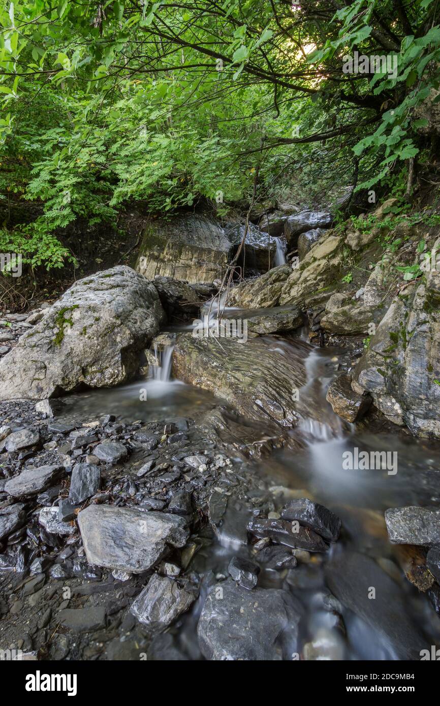 Wonderful clear water creek in french alps with rocks Stock Photo
