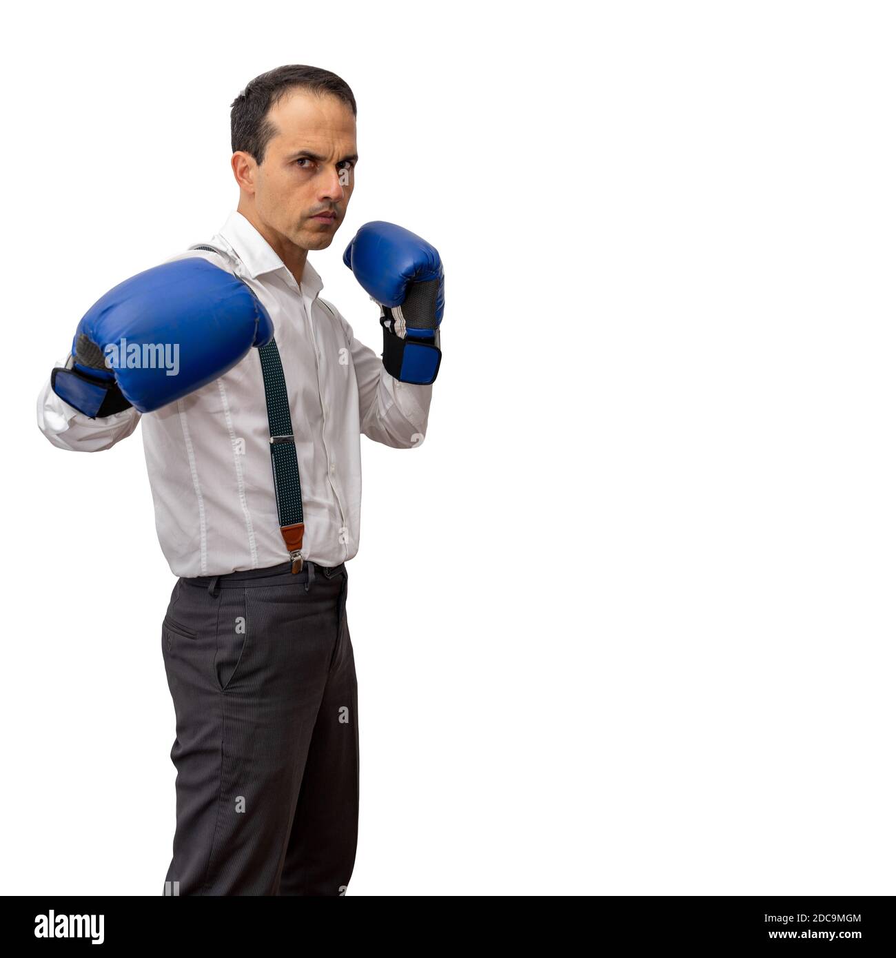 Mature man with long sleeve shirt, suspenders and boxing glove, doing fighting pose. Stock Photo