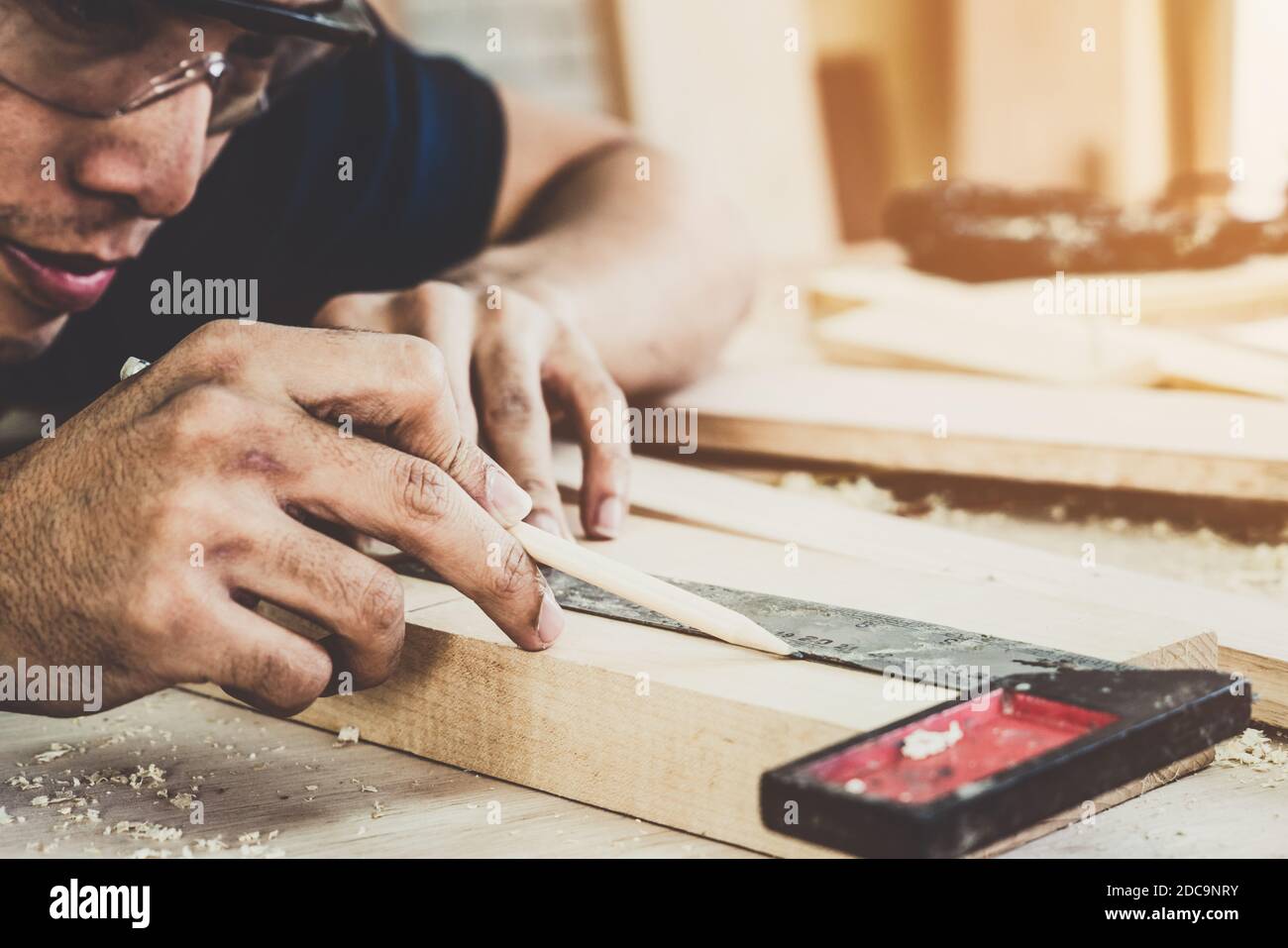 Carpenter working on wood craft at to produce construction