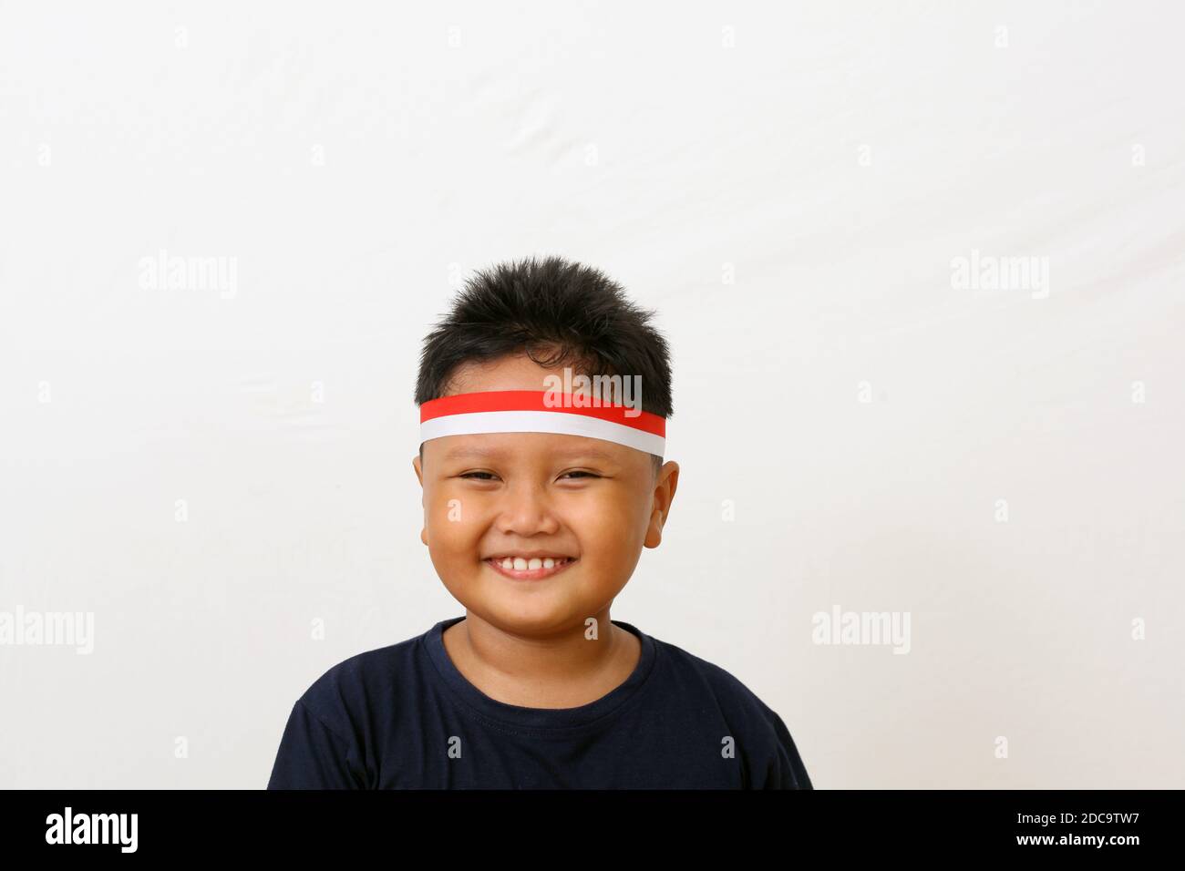 Adorable kids from indonesia celebrate indonesian independence day. Cheerful expressions by wearing a red and white headband as a symbol of the Indone Stock Photo