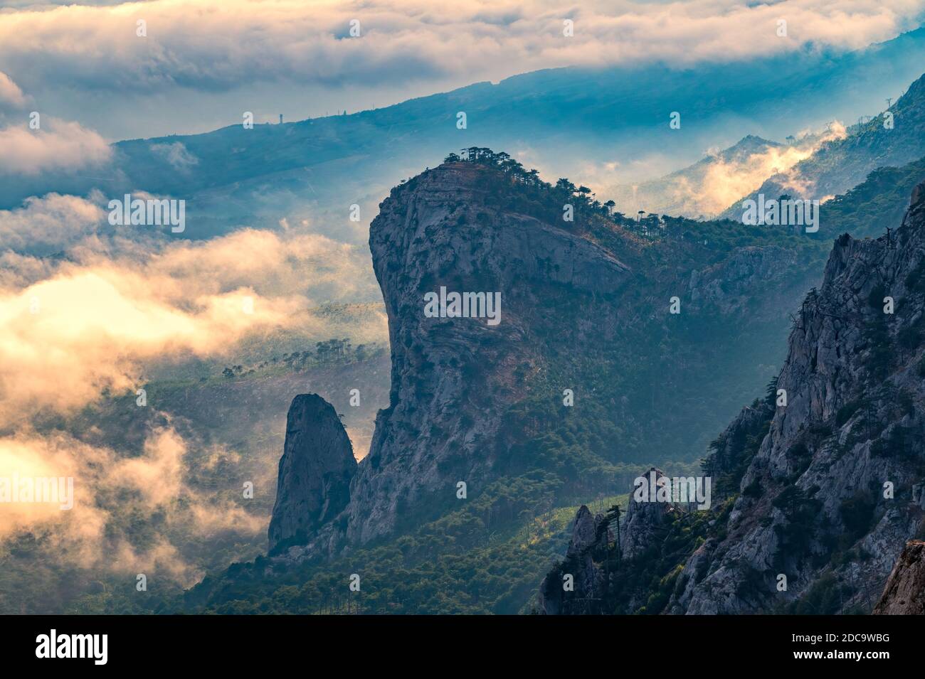 A majestic view of the rocky mountains and the valley in fog and clouds ...