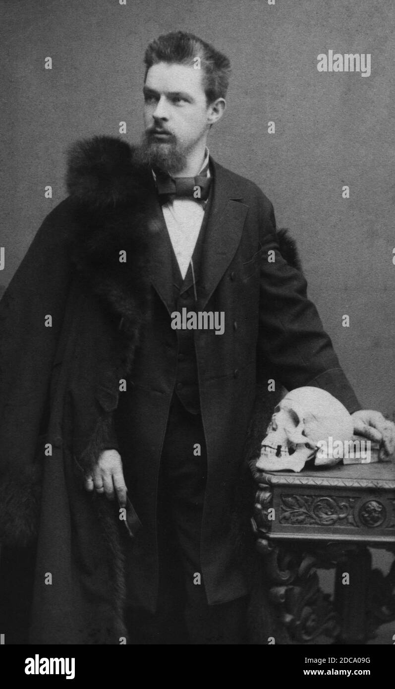 In 1884, here is a young Chicago (America) man studying to become a doctor. His school was in Munich, Germany. In those days, having a human skull displayed apparently was a highly recognizable symbol of being in the doctoring business. We do not know if he returned to Chicago after his studies.   To see my other medically-related images, Search:  Prestor  vintage   medical Stock Photo