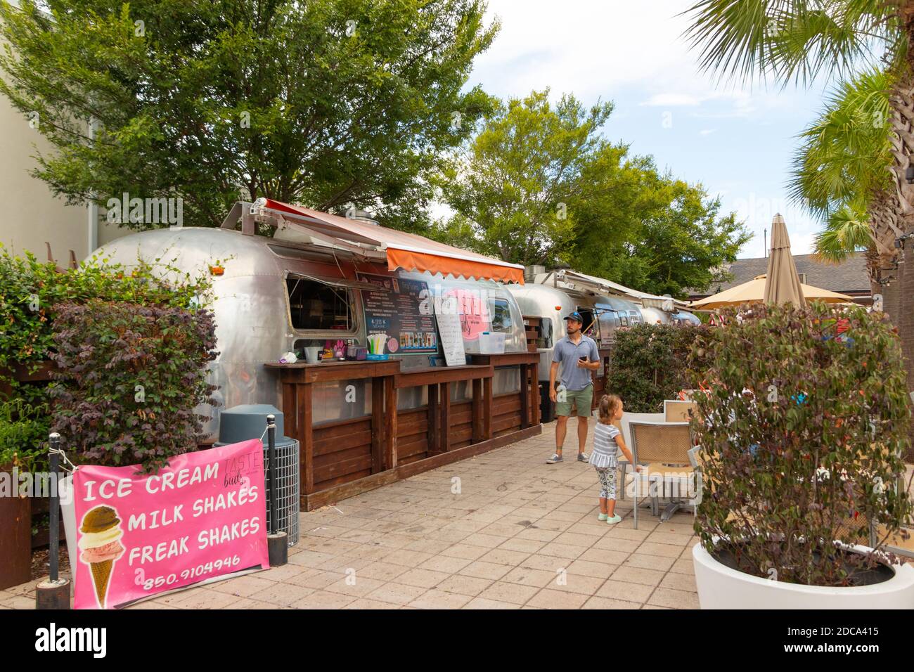 man and child outside Airstream cafe and ice cream servery in Pensacola Florida Stock Photo