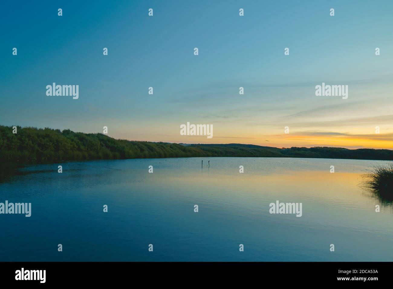 Calm peaceful lake sunset with colorful sky on background and smooth ...