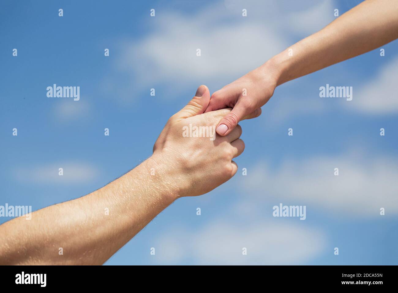 Hands of man and woman reaching to each other, support. Solidarity, compassion, and charity, rescue. Giving a helping hand. Hands of man and woman on Stock Photo