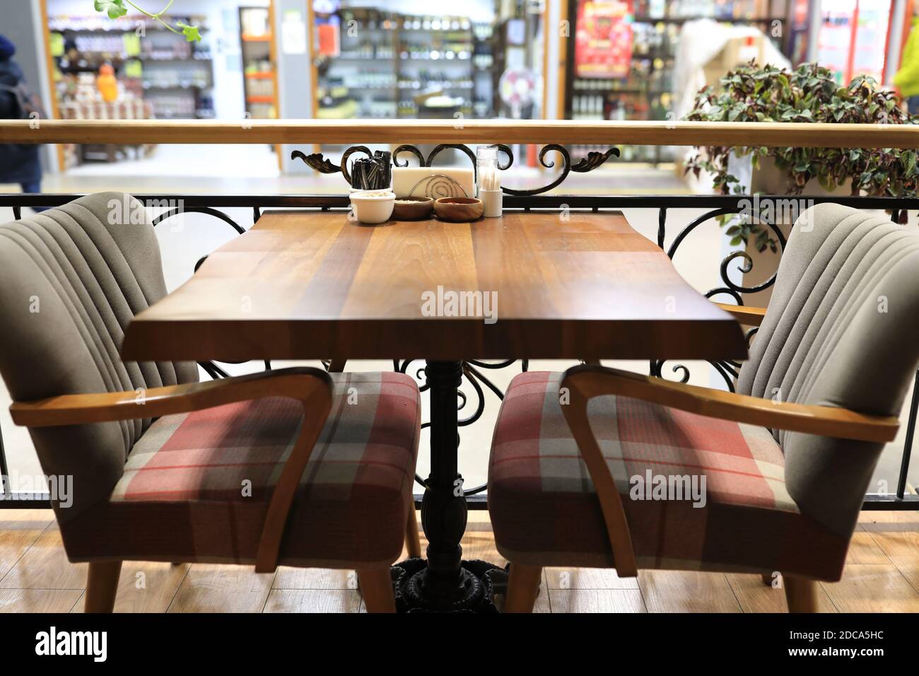 Wooden dining table with armchairs in restaurant Stock Photo Alamy