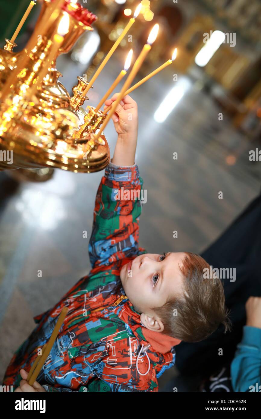 Child put candles in Russian Orthodox Church Stock Photo Alamy