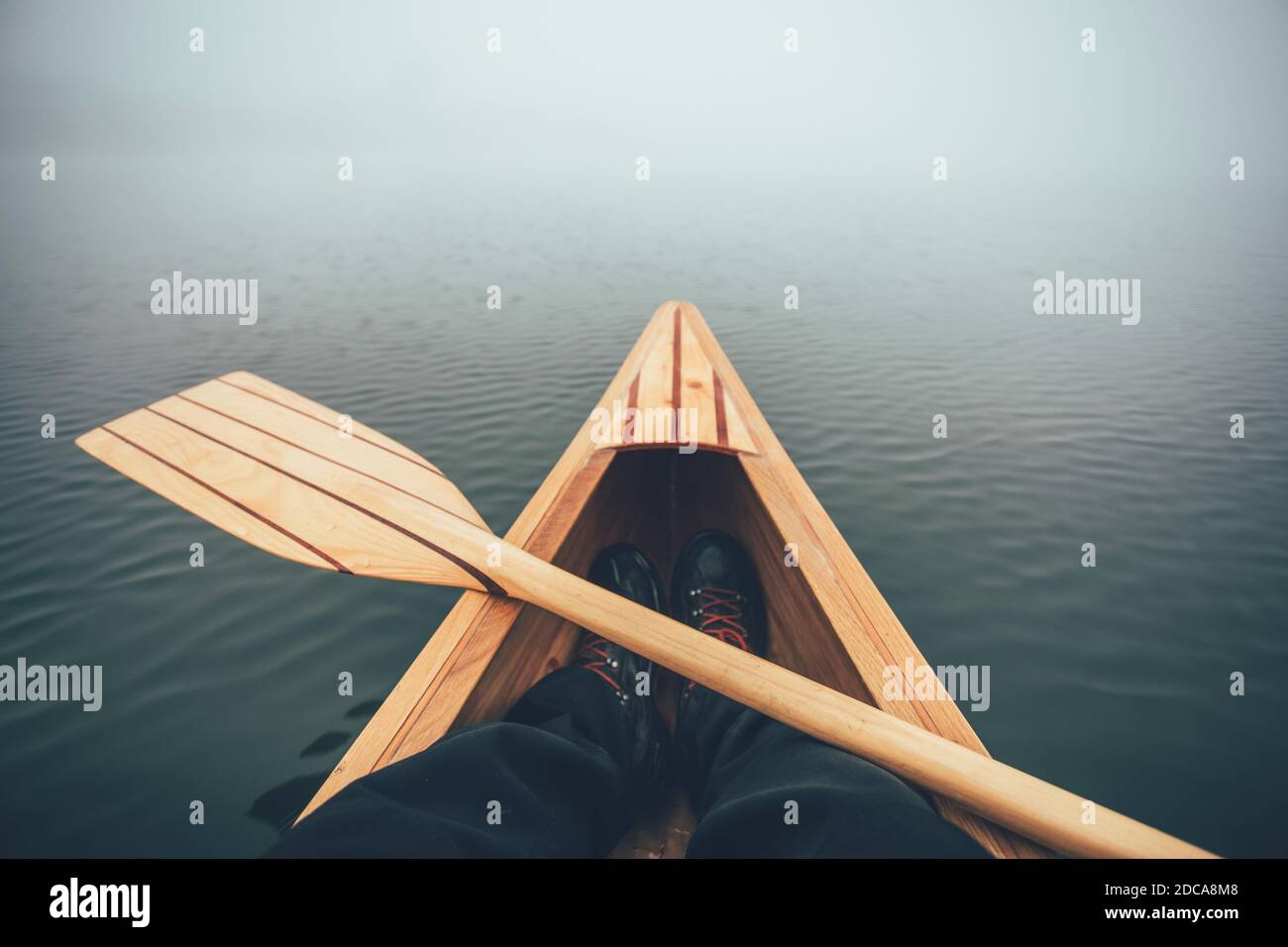 Winter canoeing. Canoe bow and paddle on the foggy lake Stock Photo Alamy