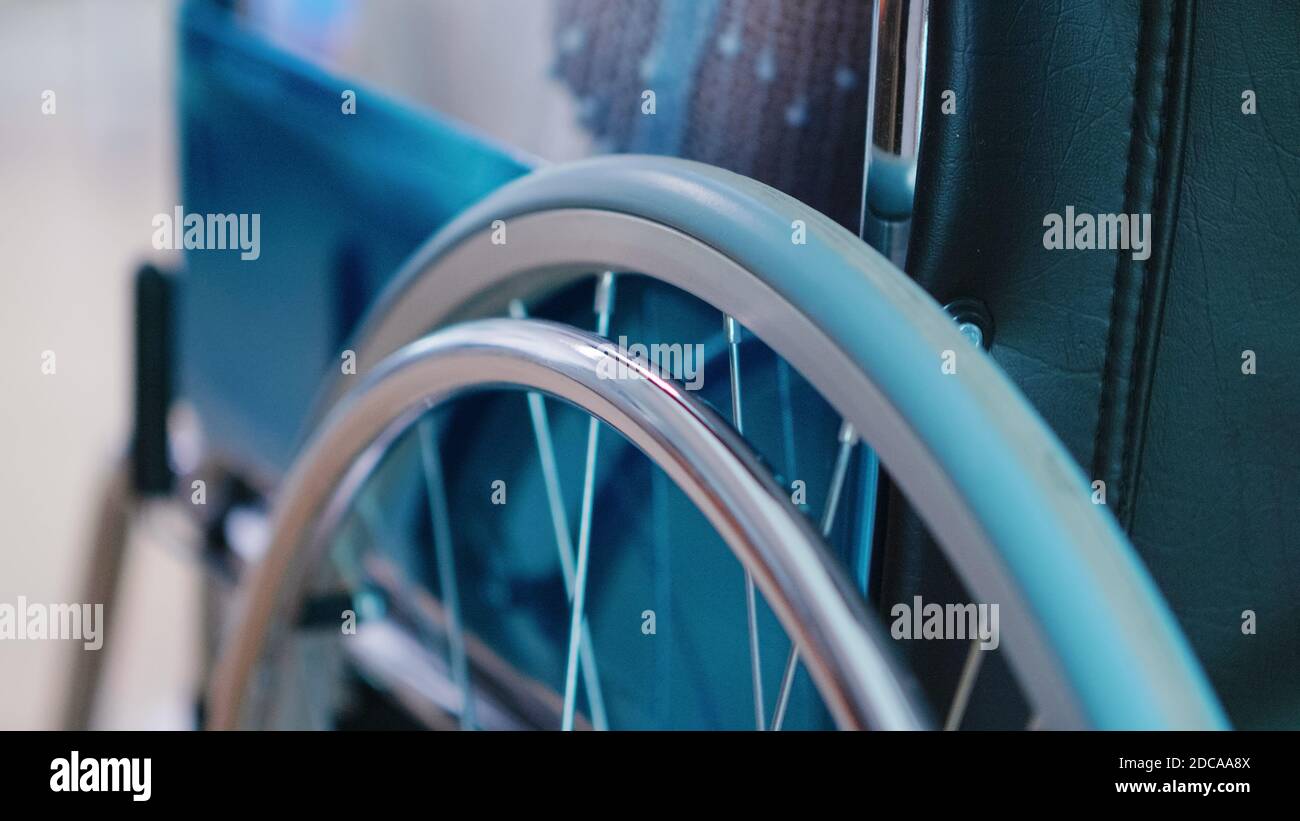 Following shot of elderly woman in wheelchair. Moving through the