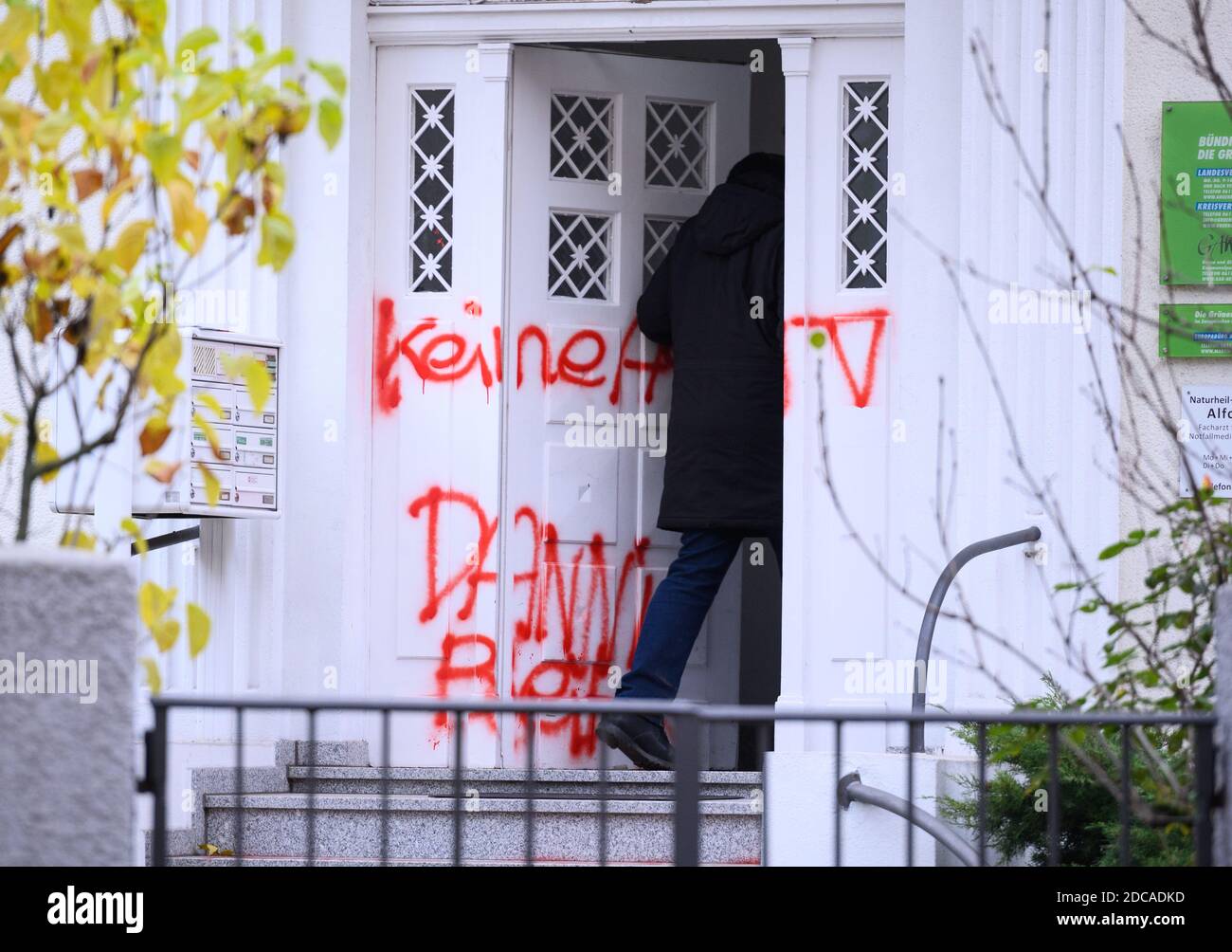 Wiesbaden, Germany. 20th Nov, 2020. A man goes to the party headquarters of Bündnis90/The Greens in Hesse. The entrance door is smeared with the slogan "No A49 Danni stays". Activists from Robin Wood, environmental and nature conservation organisation, have occupied two trees in front of the party headquarters of the Hessian Greens in the state capital. The organization is protesting against the clearings in connection with the expansion of the A49 and wants to remind the Greens in Hesse of their political responsibility. Credit: Andreas Arnold/dpa/Alamy Live News Stock Photo