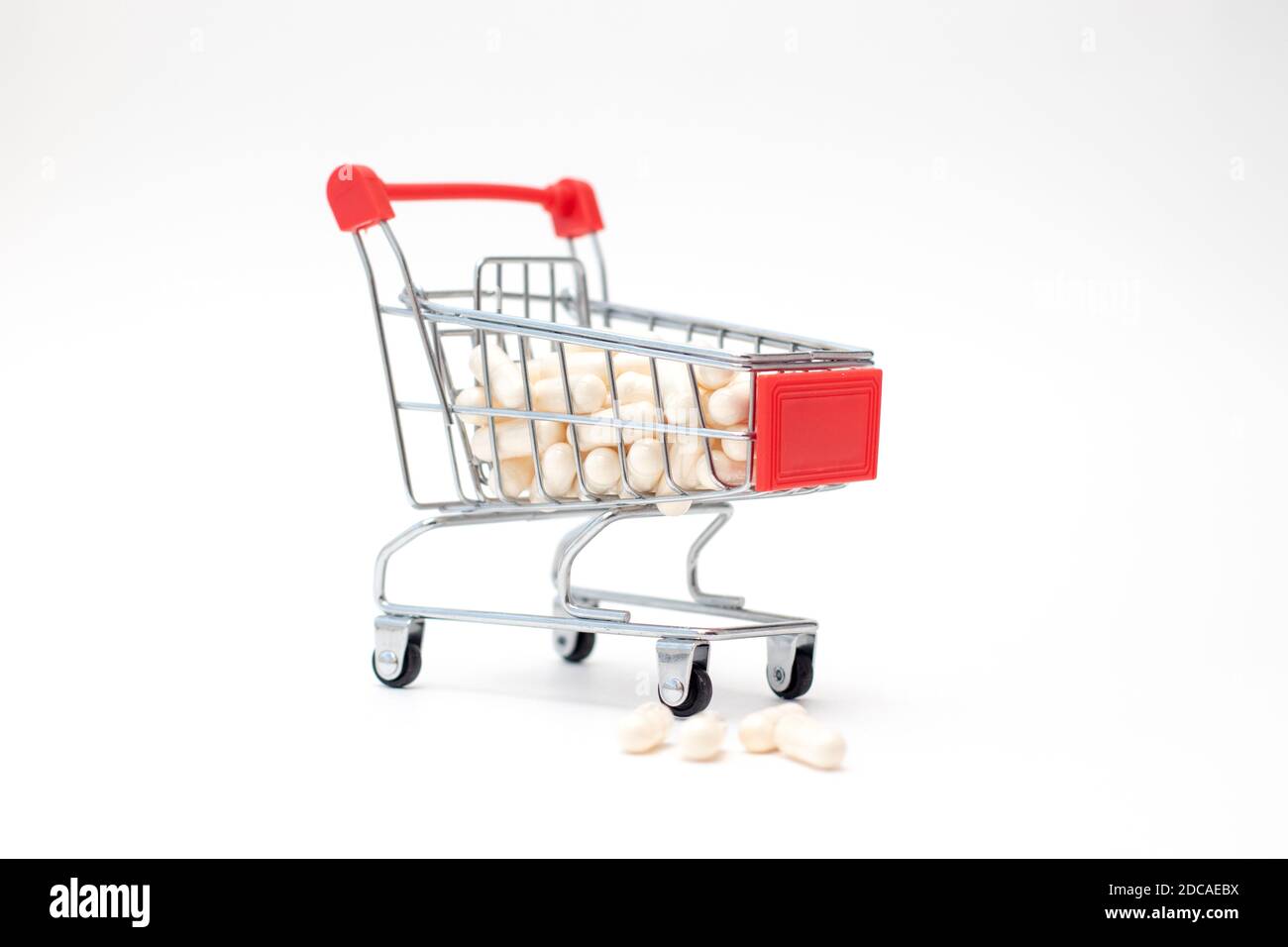 Cart Capsule Pills and capsules in shopping cart on white background Stock Photo - Alamy