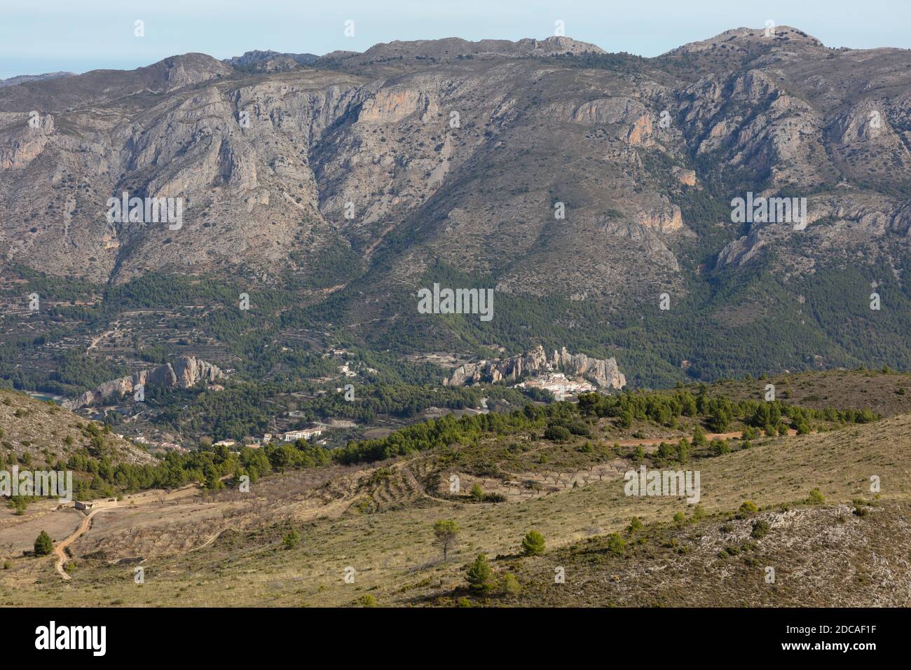 panoramic view of Castell de Guadalest between the mountains with the pine forest Stock Photo