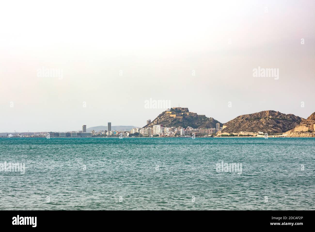 General view of Alicante city from the blue Mediterranean sea with the port, building and the castle Stock Photo