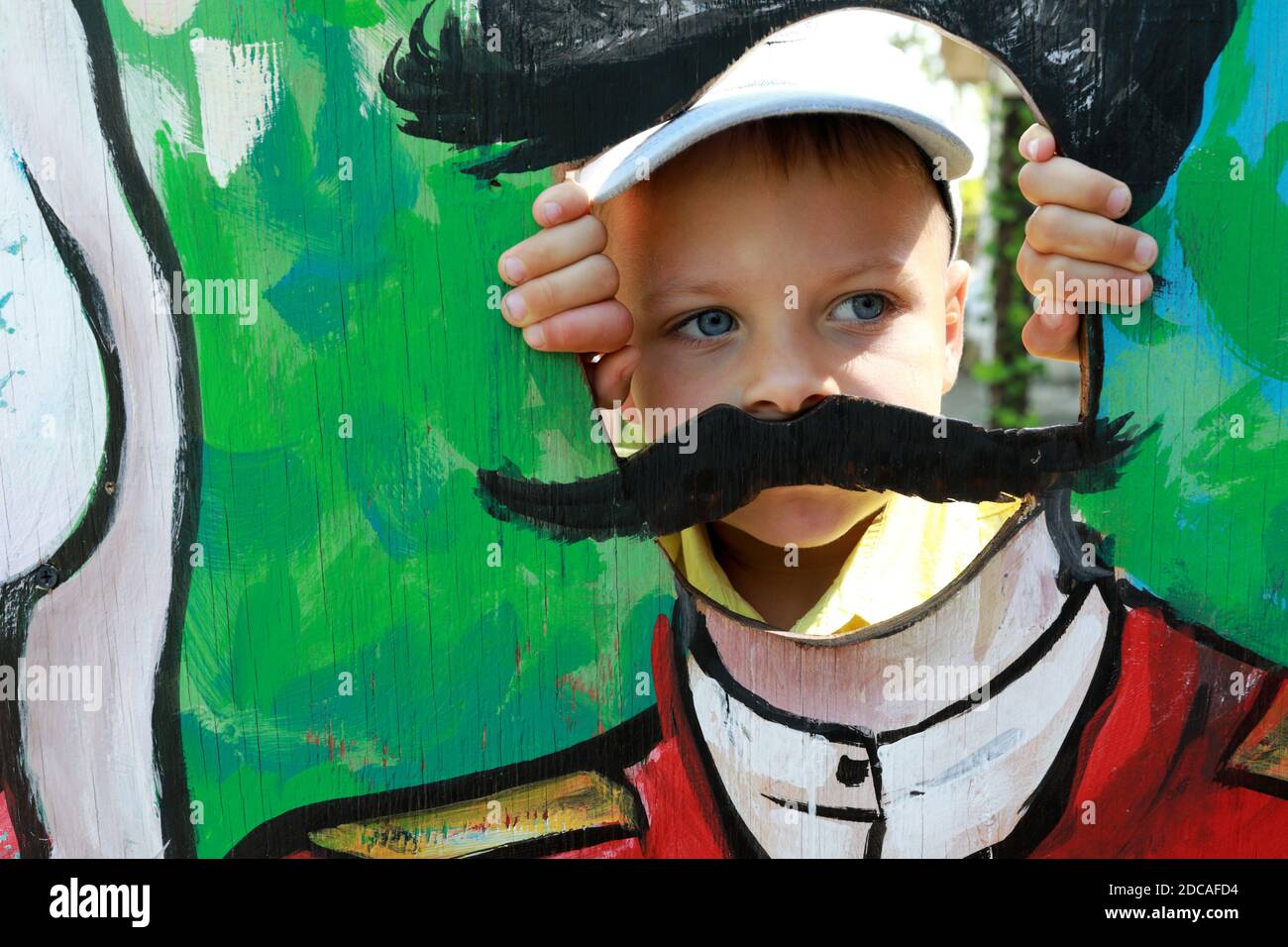 Serious boy face in Cardboard Cutouts Hole Stock Photo Alamy