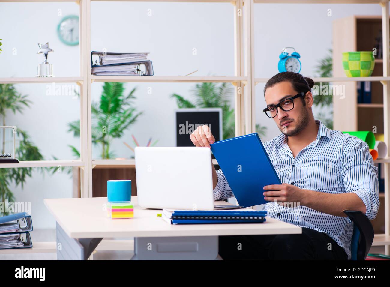 Young employee working in the office Stock Photo