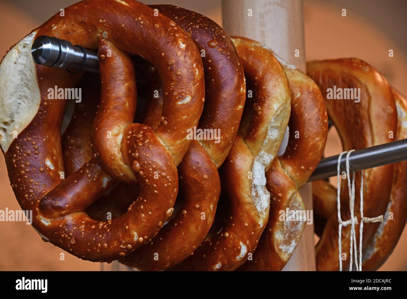 Close up several fresh traditional German pretzel bread knots hanging