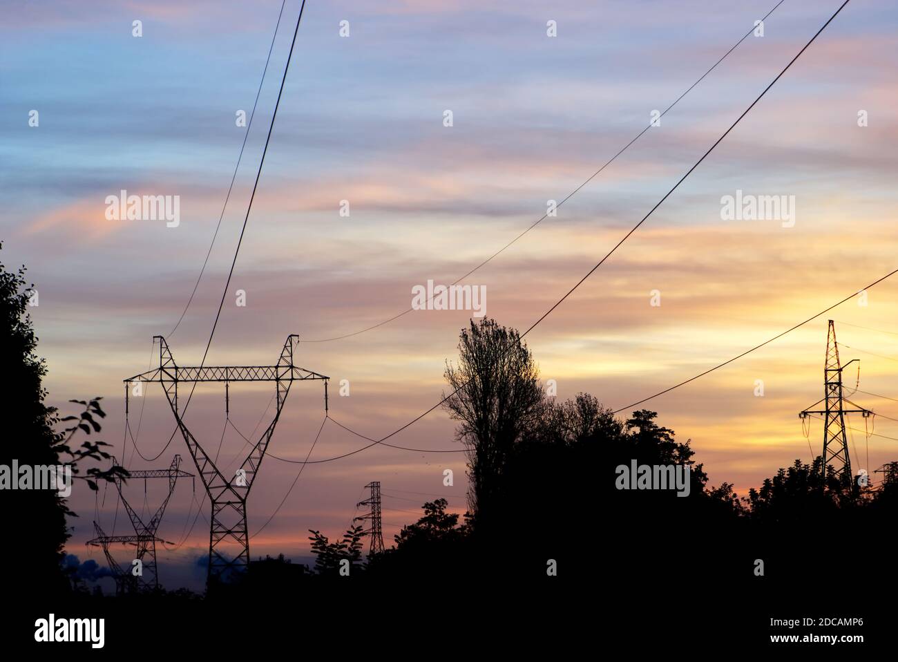 Electricity pylons and power lines at sunrise/sunset Stock Photo - Alamy