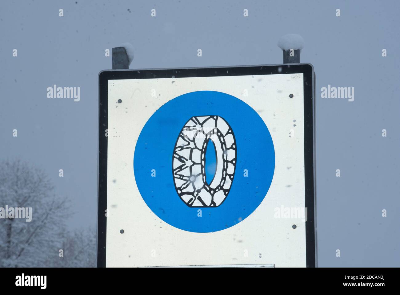 snow chain obligation traffic sign in the mountains in winter Stock Photo