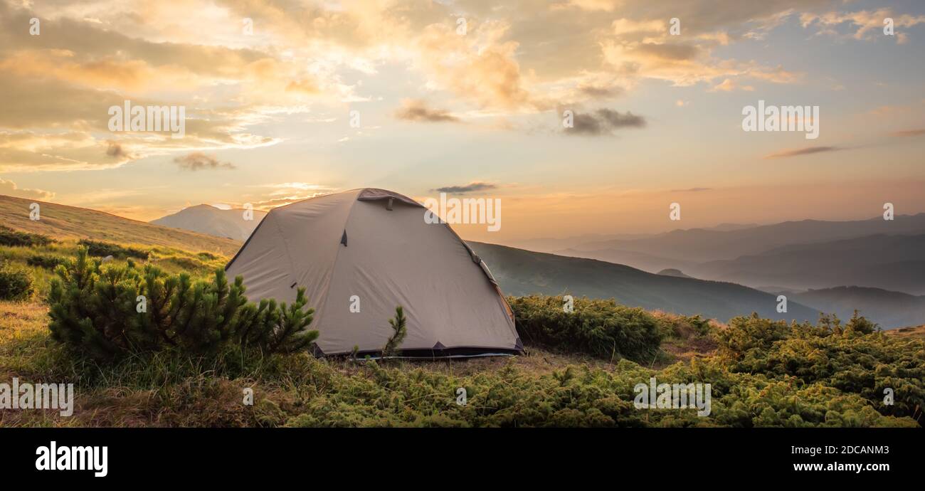 Camping tent in morning sun ray. Active lifestyle. Tatra mountains