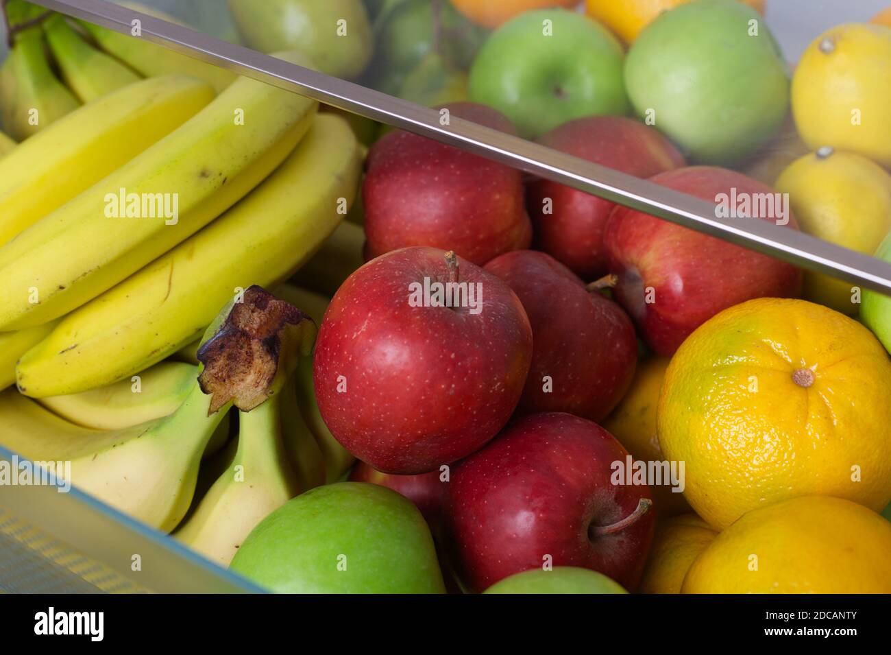 Box full of fresh fruit inside of a fridge. Close up. Stock Photo
