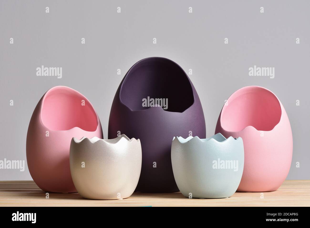 Set of multicolored vases in the form of an eggshell on a gray background for easter Stock Photo