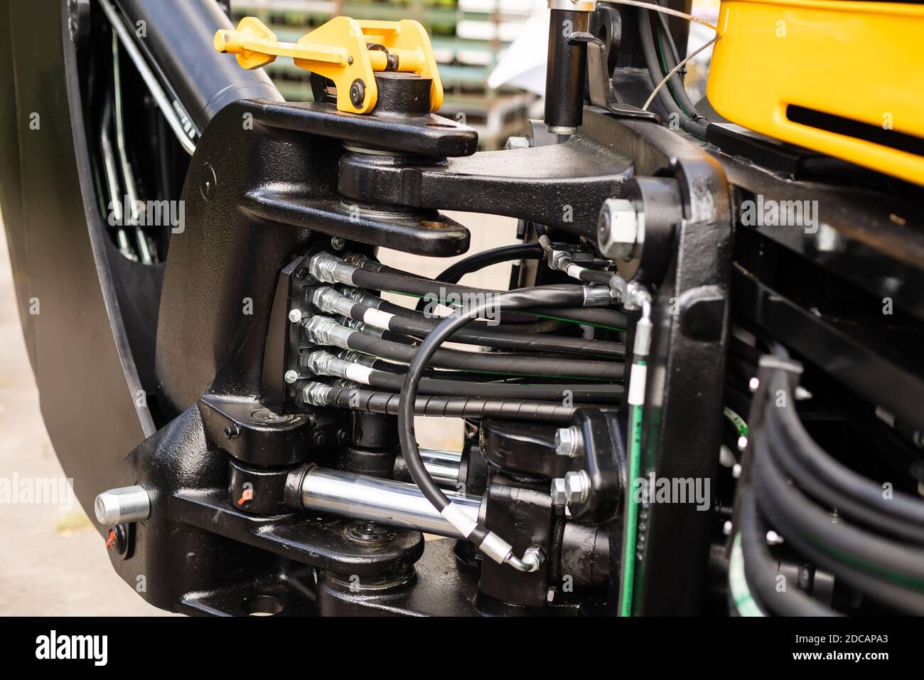 Part of agriculture machine close up with hydraulic system, steel tubes