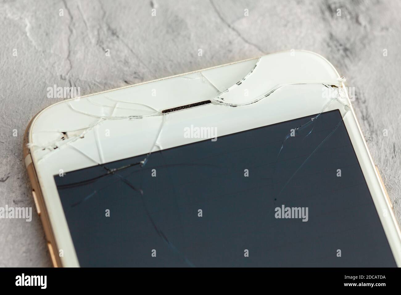 Broken phone with a crack on the display glass. Stock Photo