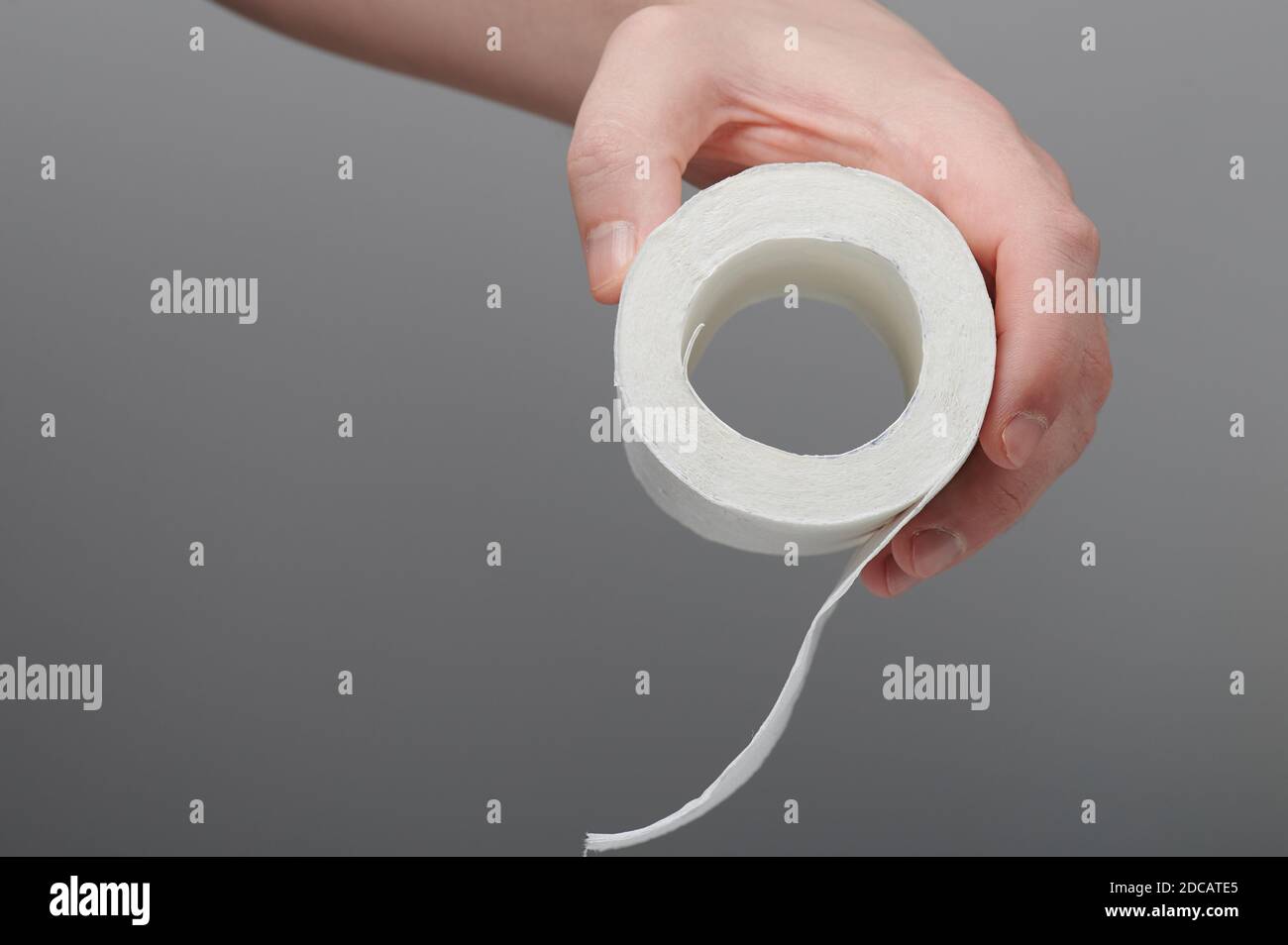 Last piece of toilet paper in hand side view isolated Stock Photo