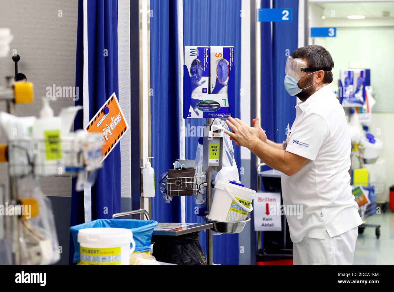 A staff member desinfects his hands at the triage zone of the University  Hospital Zurich (USZ), as the spread of the coronavirus disease (COVID-19)  continues, in Zurich, Switzerland November 19, 2020. Picture