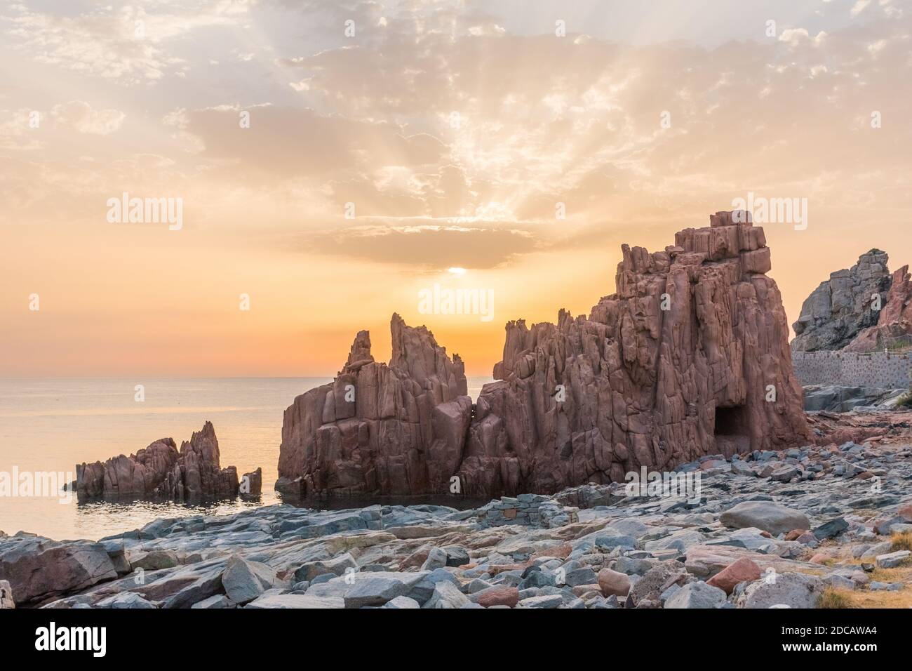 Geological feature called 'Rocce rosse' (red rocks) along the coastline in Arbatax (Sardinia, Italy) at the sunrise Stock Photo