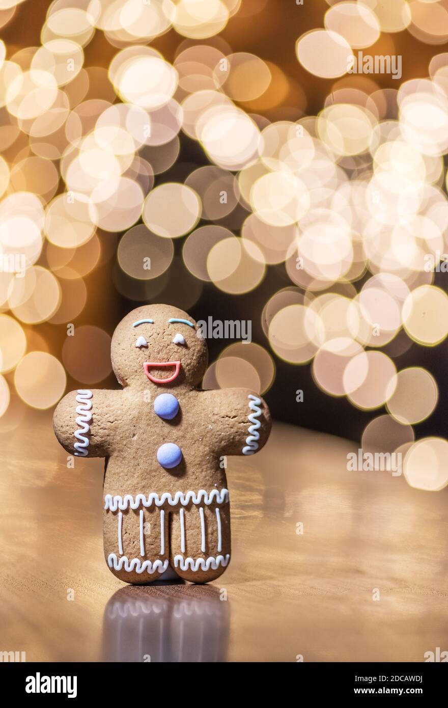 Gingerbread man on a Christmas background. Background with cookie and beautiful bokeh. Stock Photo
