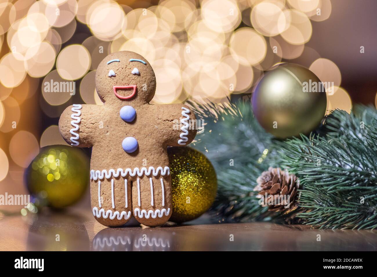 Gingerbread man on a Christmas background. Background with cookie and New Year decorations. Stock Photo