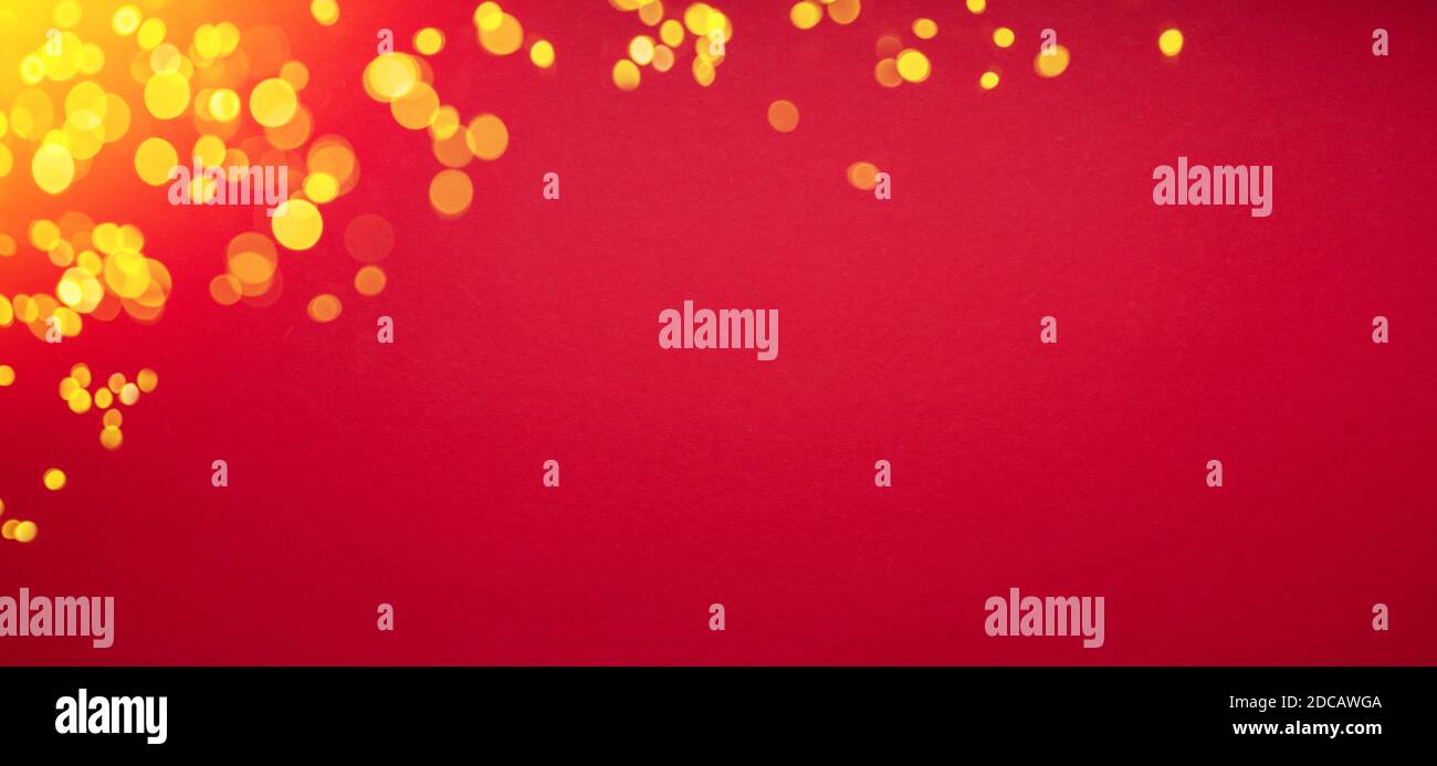 Red paper New Year or Christmas background and bokeh golden lights. Stock Photo