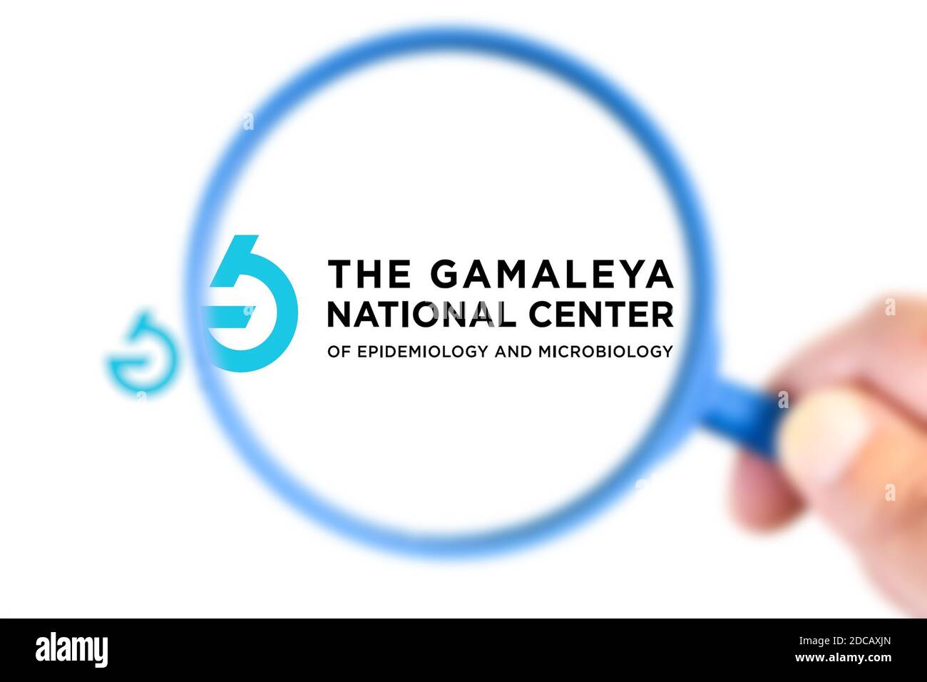 Benon, France - November 20, 2020:Gamaleya National Center research laboratory logotype enlarged with a magnifying glass.This laboratory has developed Stock Photo