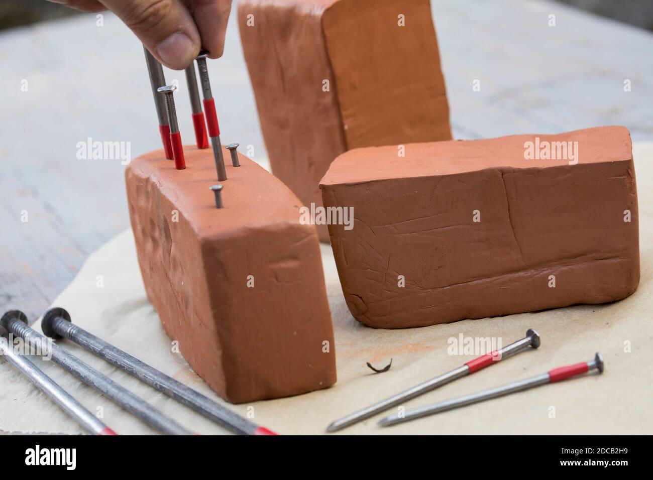 bees box is made of clay block, with different nails ar made holes of different size, series picture 7/13, Germany Stock Photo