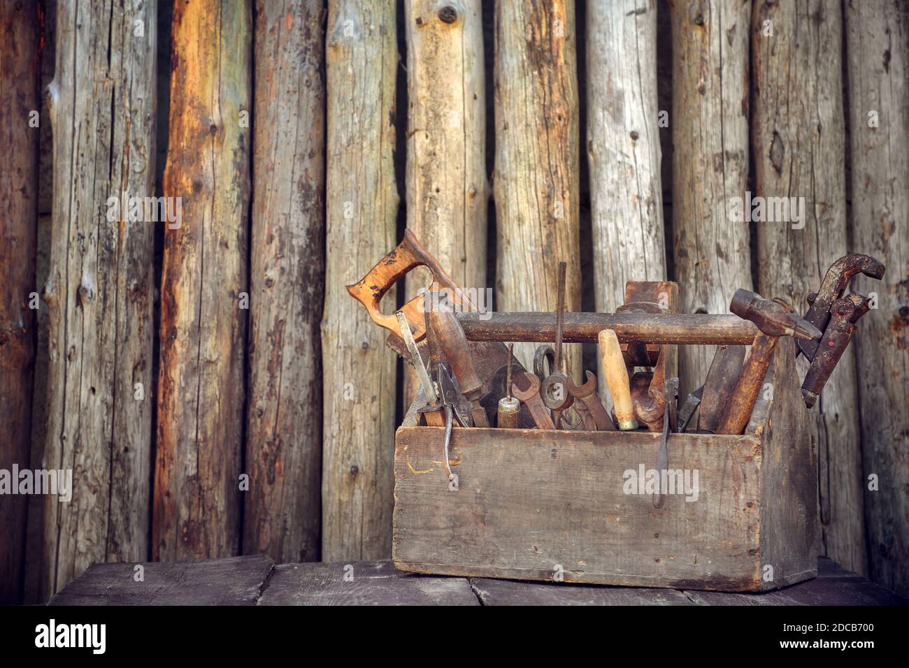 Old tool box on table on wood background Stock Photo - Alamy