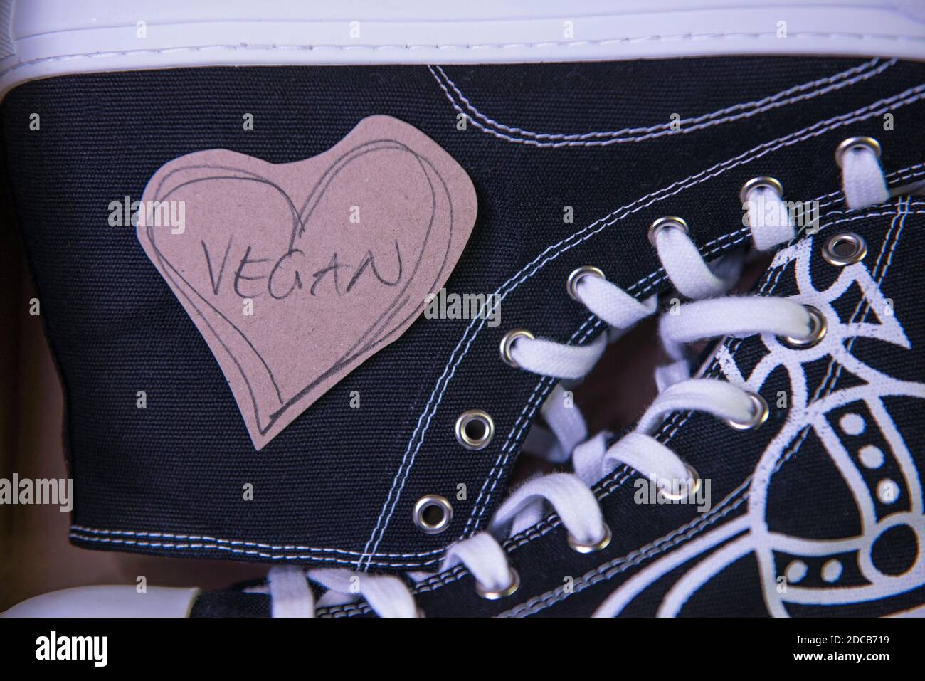 Vivienne Westwood vegan Plimsoll high top trainers with Orb logo design. Stock Photo