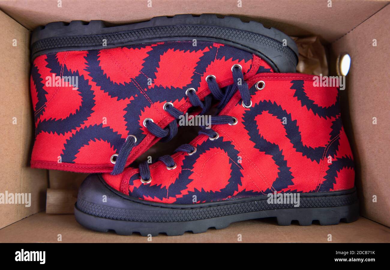 Vivienne Westwood red squiggle design vegan trainers. Stock Photo