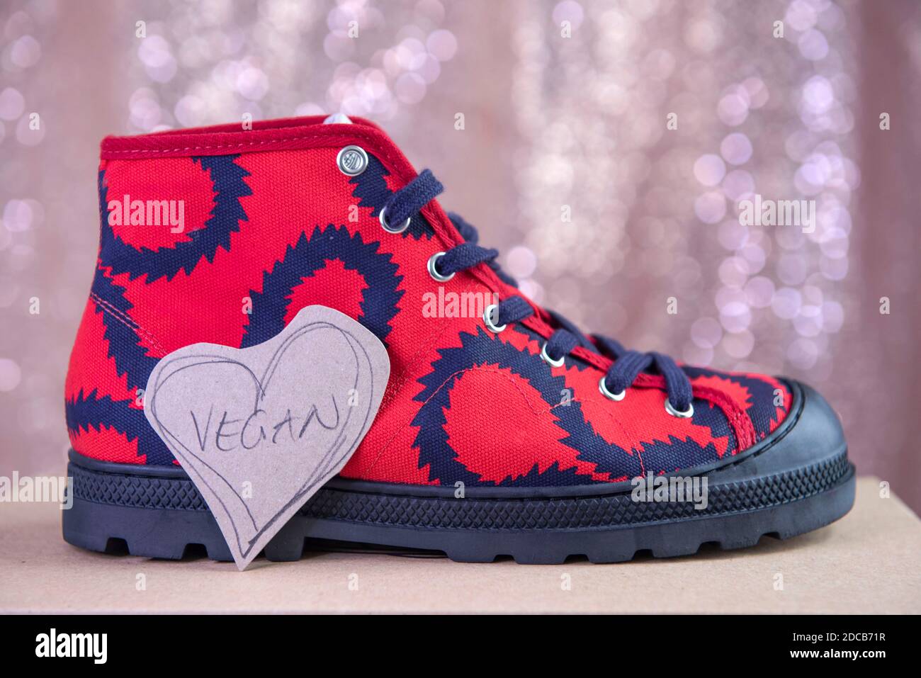 Vivienne Westwood red squiggle design vegan trainers. Stock Photo