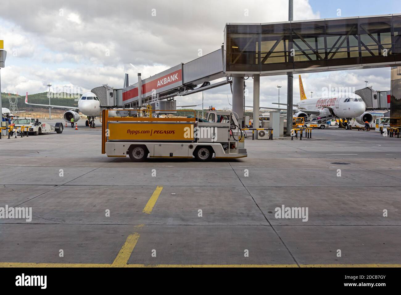 Airport maintenance truck and passenger boarding bridge in Sabiha