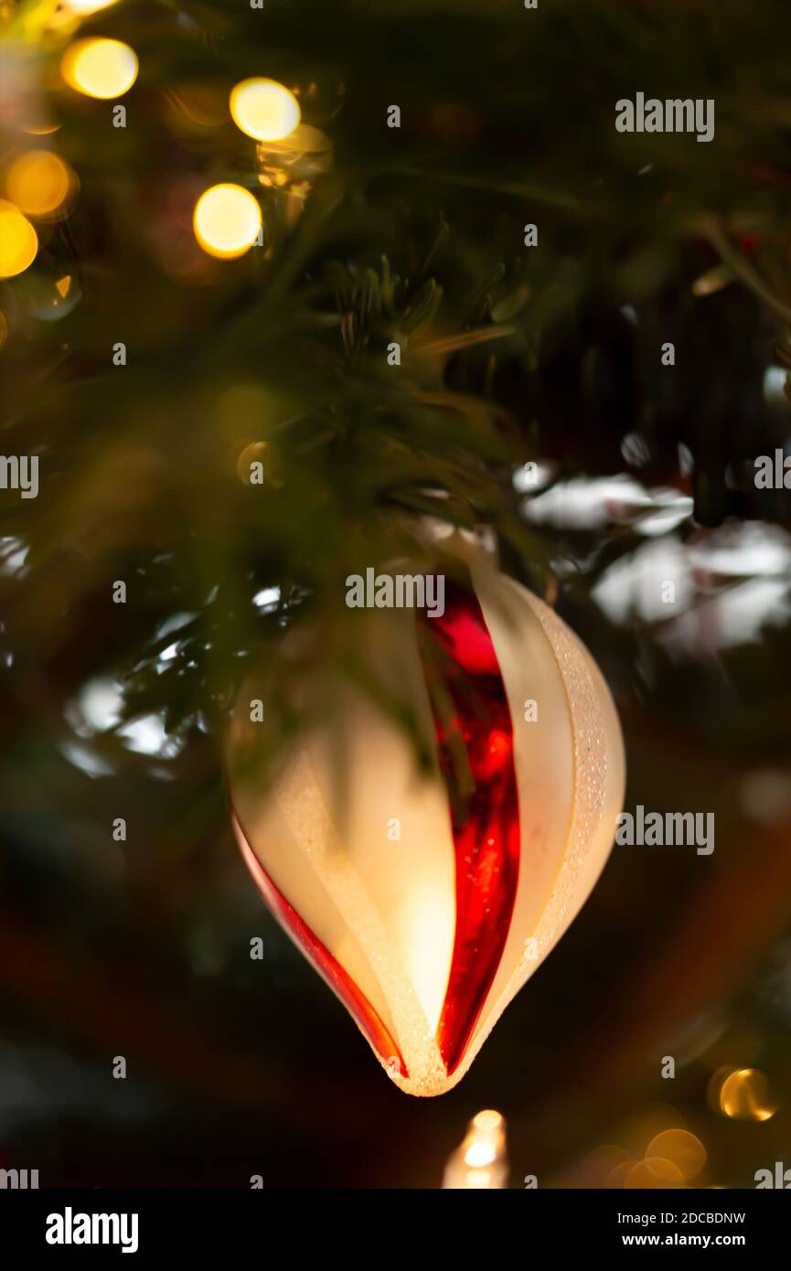 Decorated Christmas tree, real Nordmann fir in front of blurred background. Macro photography shows a christmas tree ball and a lot of bokeh as textur Stock Photo