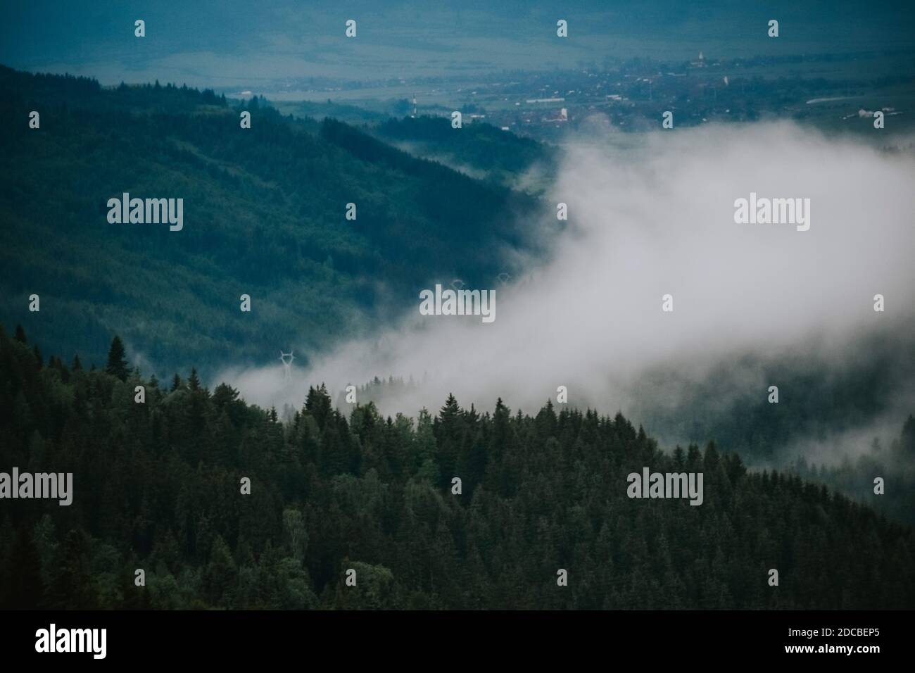 A mesmerizing shot of a beautiful mountainous landscape in a foggy day ...