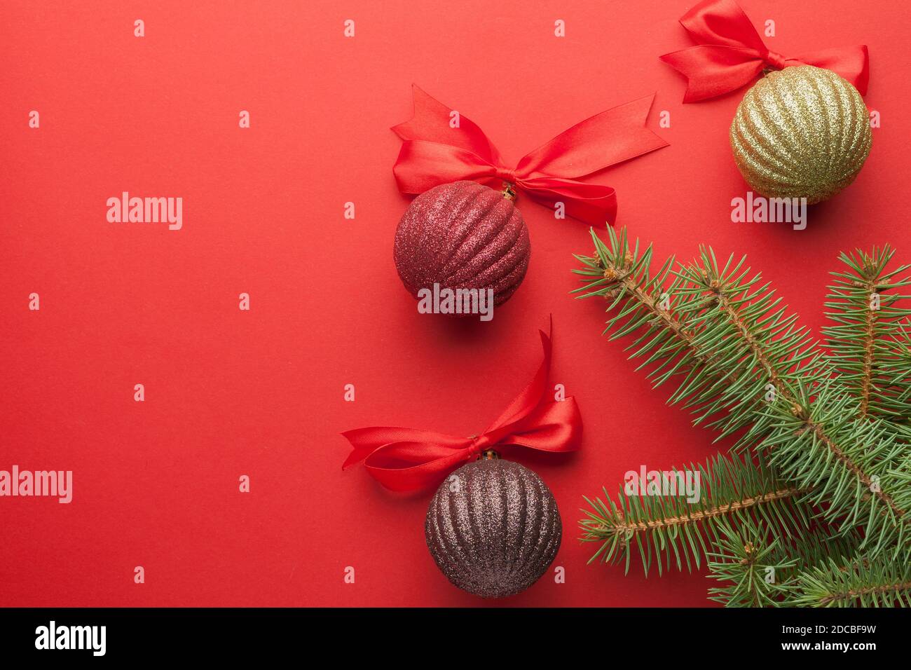 Christmas background red paper and branches of a New Year tree with ...