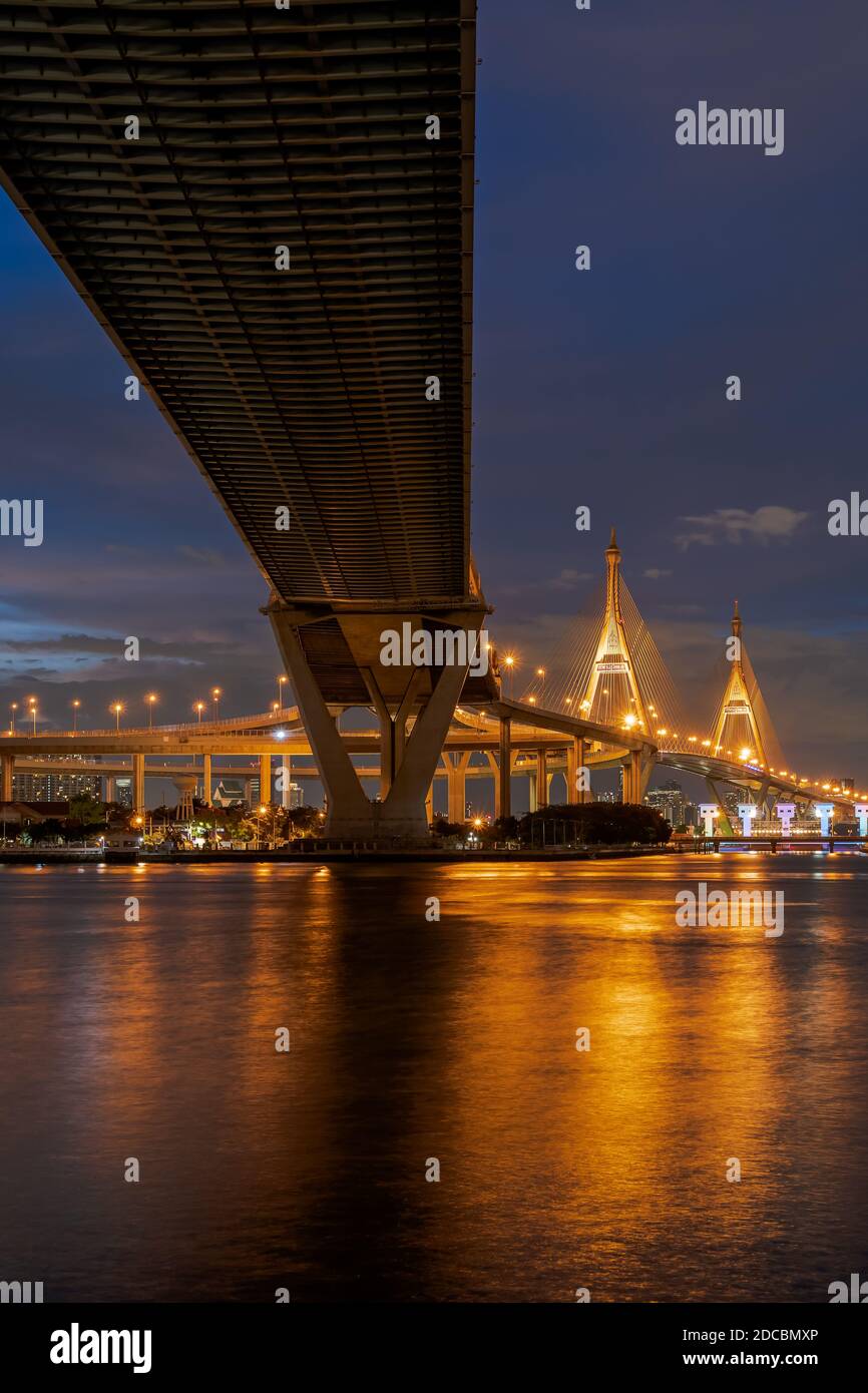 Large suspension bridge over Chao Phraya river at twilight Stock Photo