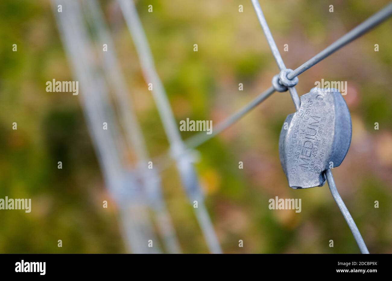Close-up of a Gripple wire joiner attached to a steel wire fencing. Stock Photo